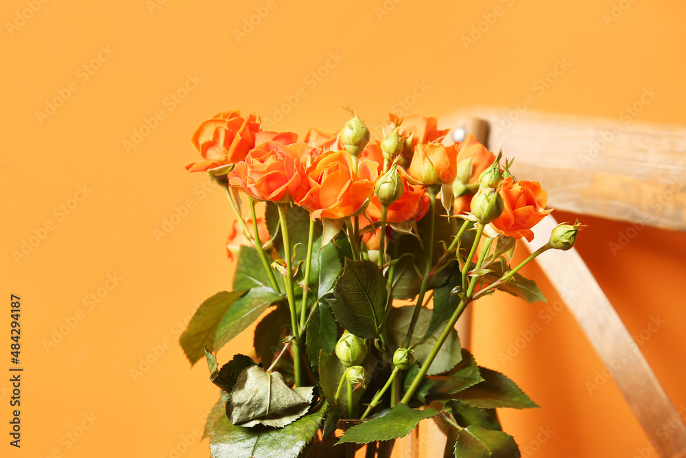 Bouquet of beautiful orange roses on color background