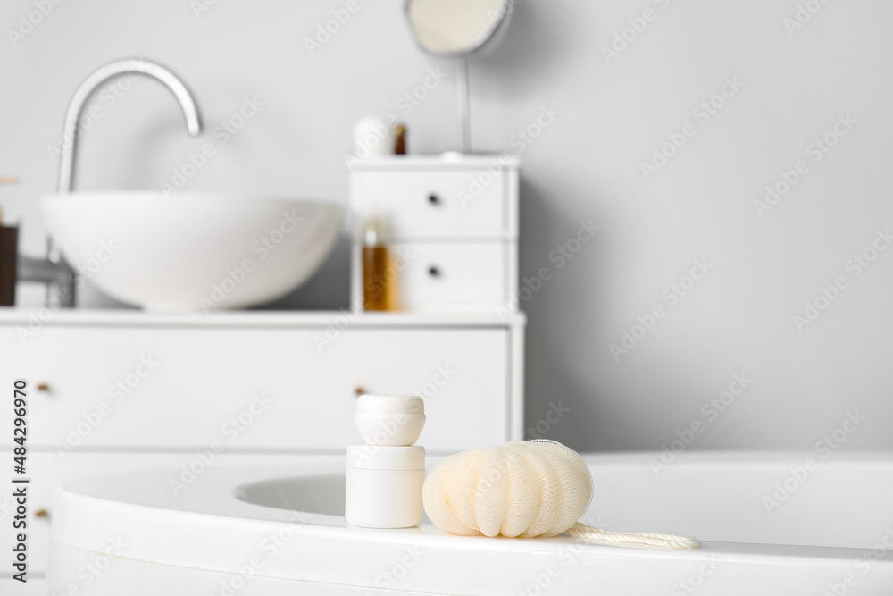 Sponge and cosmetic products on bathtub