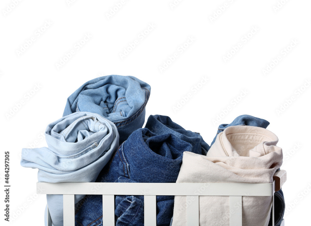 Basket with different female pants on white background, closeup