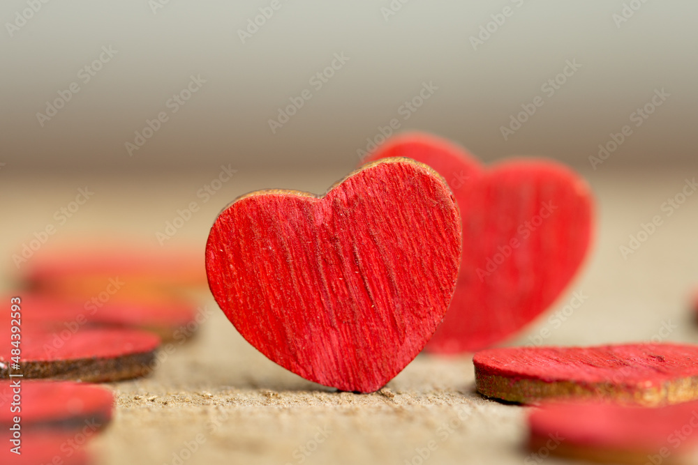 Valentines Day greetings concept. Little red wooden hearts couple close up. Valentines greeting car