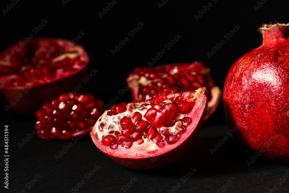 Ripe delicious pomegranate on dark background