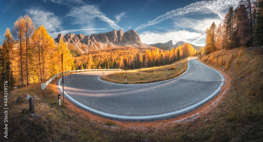 Winding road in mountains and orange trees at colorful sunset in autumn in Italy. Landscape with for