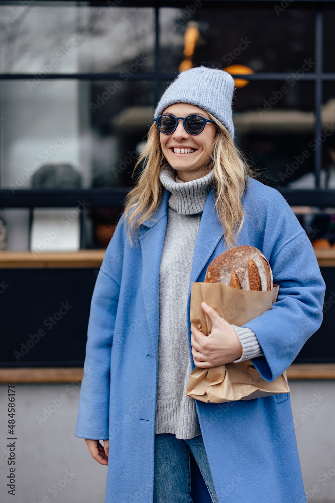 Portrait of smiling girl,  wearing sunglasses and cost, cold weather.