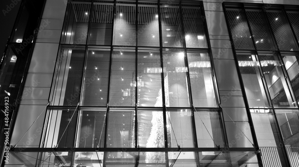 Amazing night cityscape. Office building at night, building facade with glass and lights. View with 