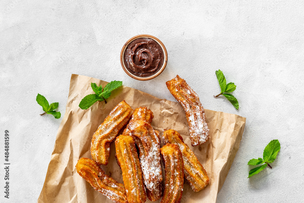 Treat churros with sugar served on baking paper