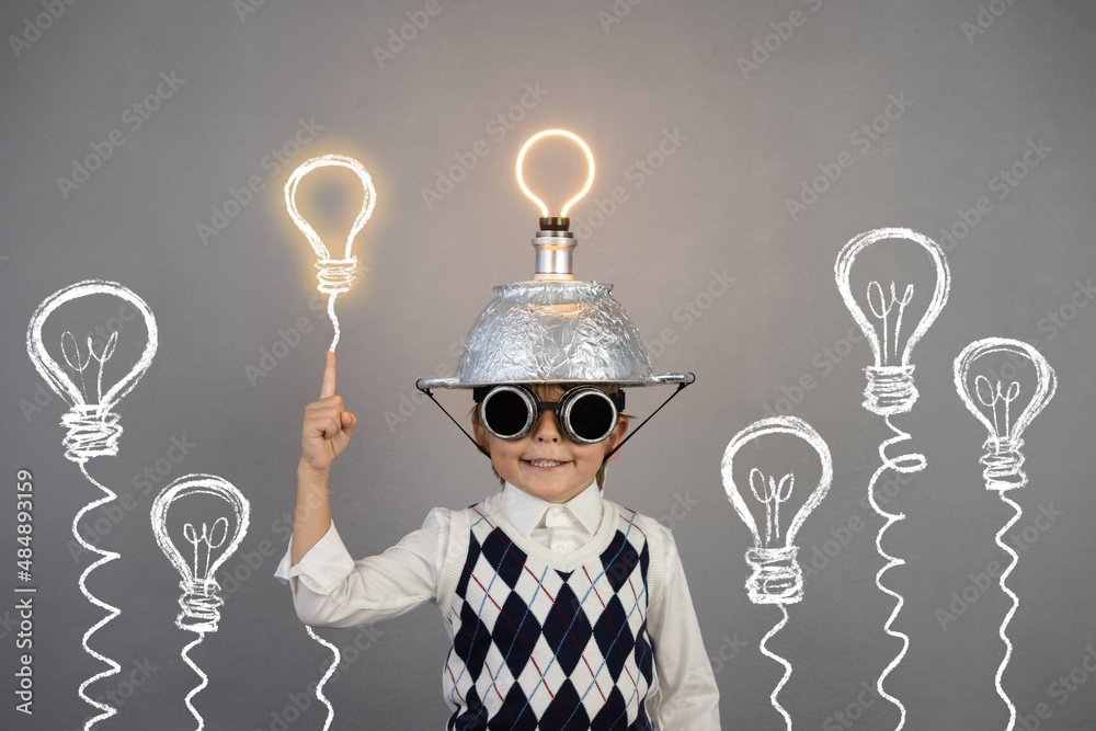 Smart child wearing funny helmet with illuminated lightbulb