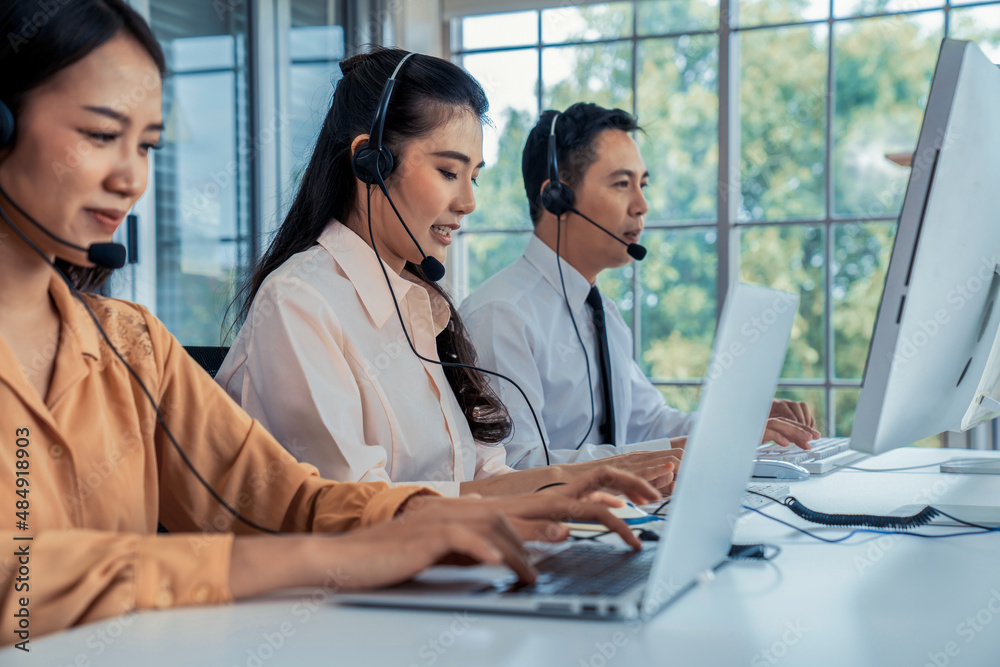 Business people wearing headset working actively in office . Call center, telemarketing, customer su