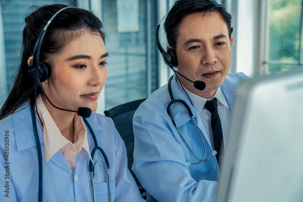 Doctor team wearing headset talking actively on video call in hospital clinic . Concept of telehealt