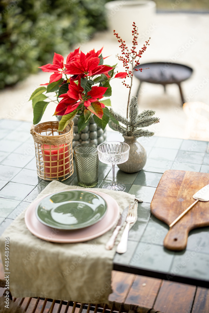 Beautifully decorated and served table for dinner at backyard on winter holidays