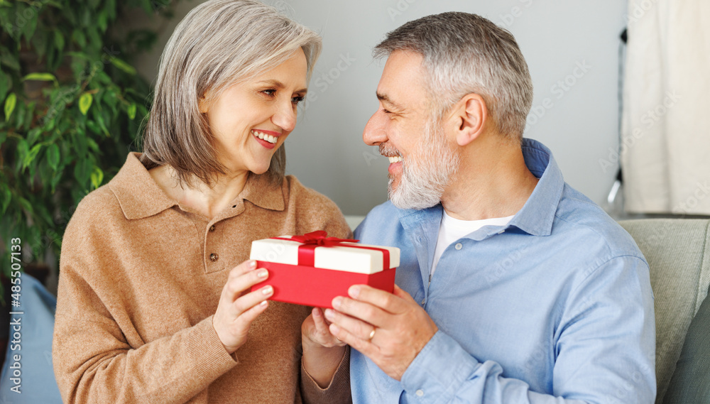 Happy romantic senior couple in love congratulating each other with Valentines Day at home