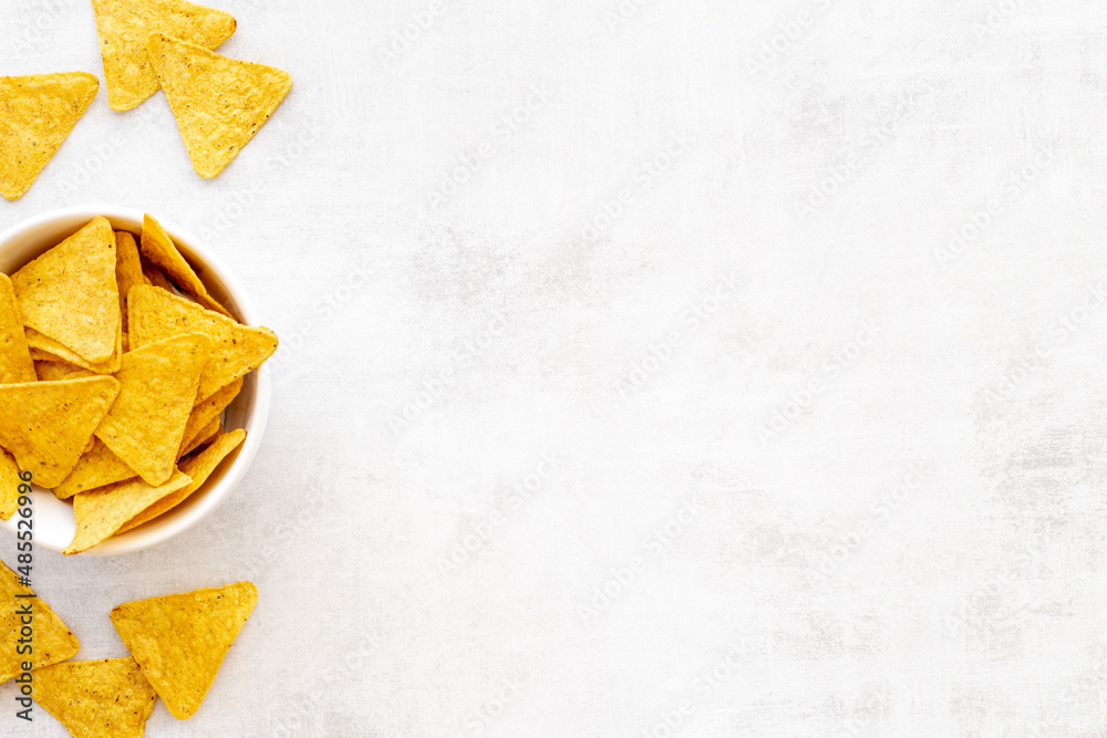 Tortilla nachos chips in bowl. Mexican food background