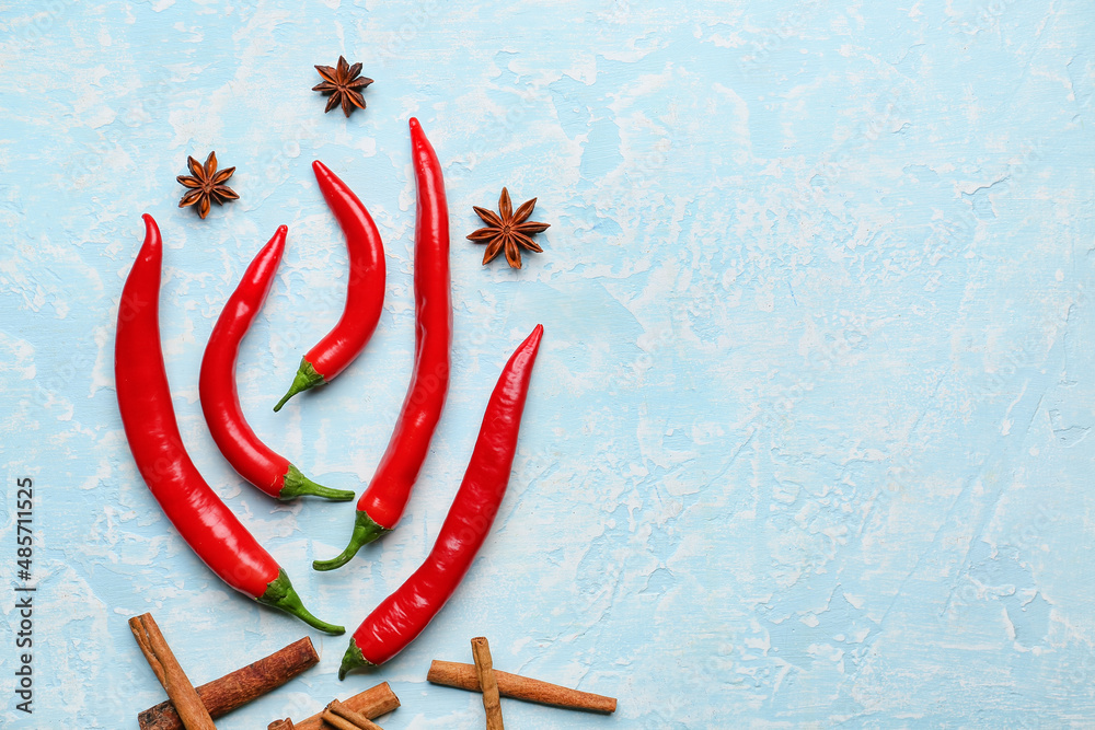 Bonfire made of hot chili peppers on blue background