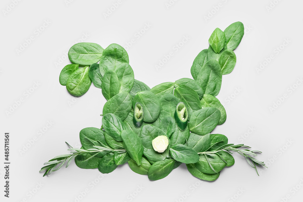 Rabbit made of green vegetables on light background