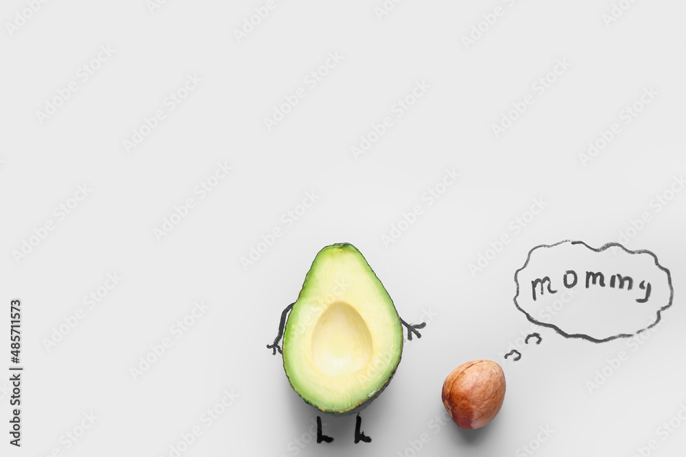 Creative composition with half avocado and speech bubble with text MOMMY on light background