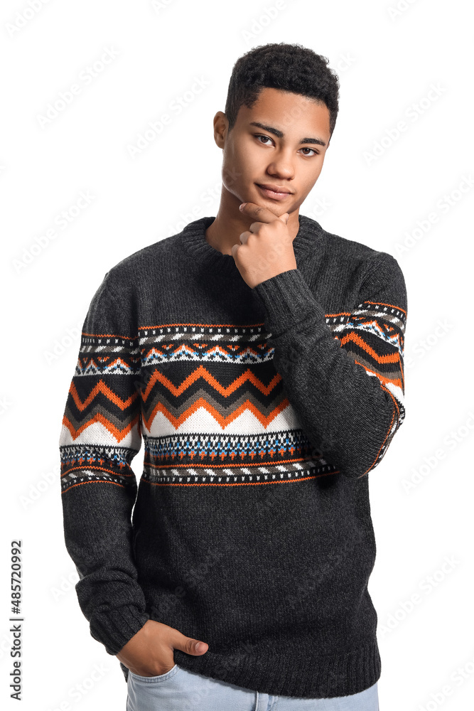 Handsome African-American guy in knitted sweater on white background