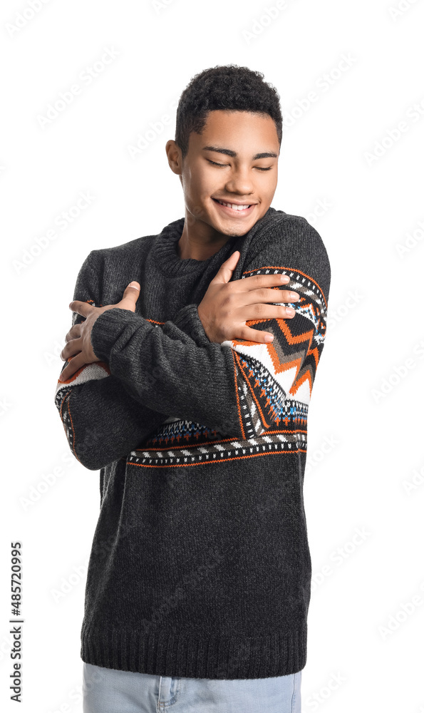 Handsome African-American guy in knitted sweater on white background