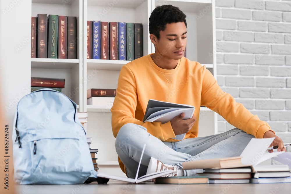 Male African-American student studying in library