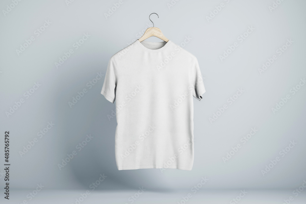 Blank white t-shirt round neck on hanger in the air with place for your brand name on abstract light