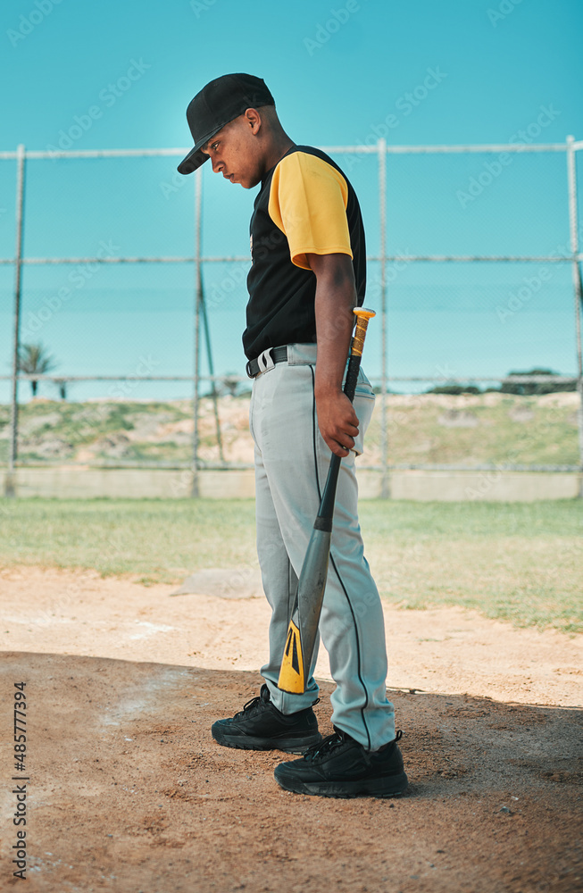 Even the best batters fail sometimes. Shot of a young baseball player holding a baseball bat while p