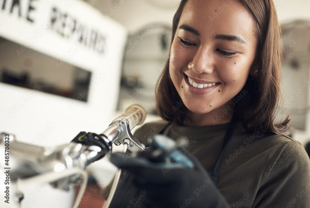 You look as good as new. Shot of an attractive young woman standing alone in her shop and repairing 