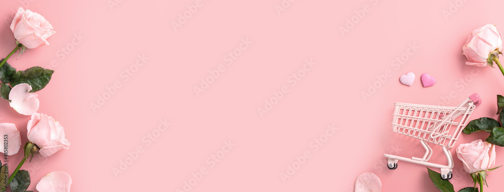 Valentines Day shopping design concept background with pink rose flower and cart on pink background