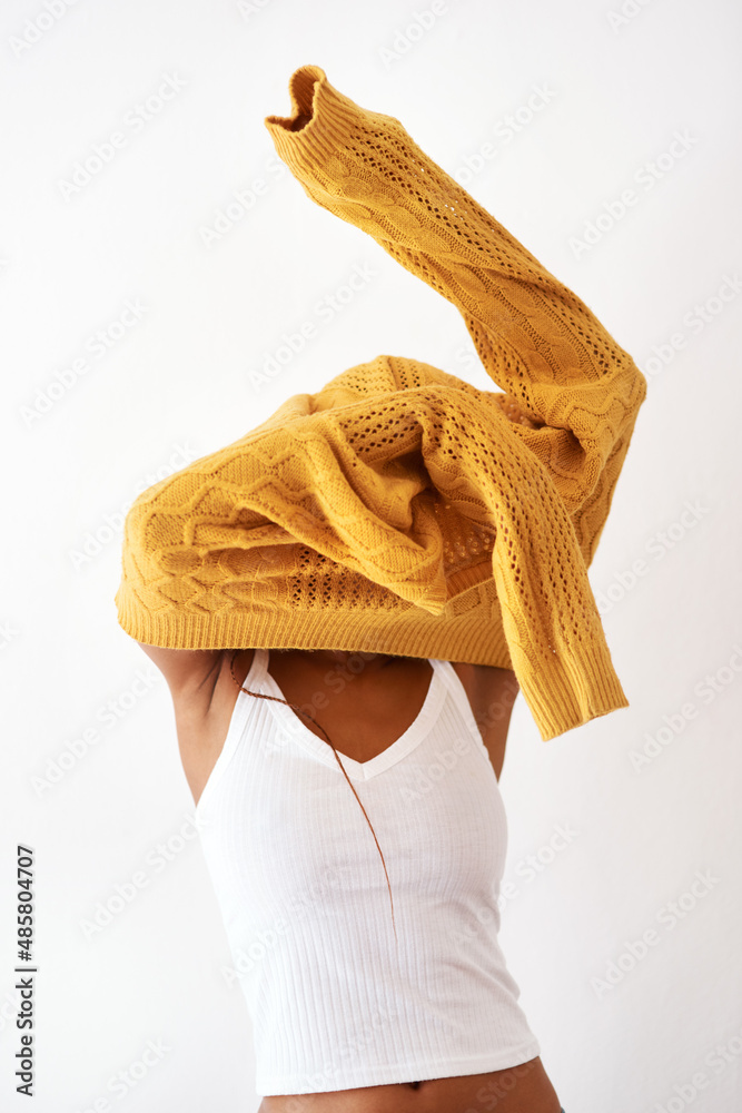 Beauty is as beauty does. Studio shot of an unrecognizable woman getting dressed against a white bac