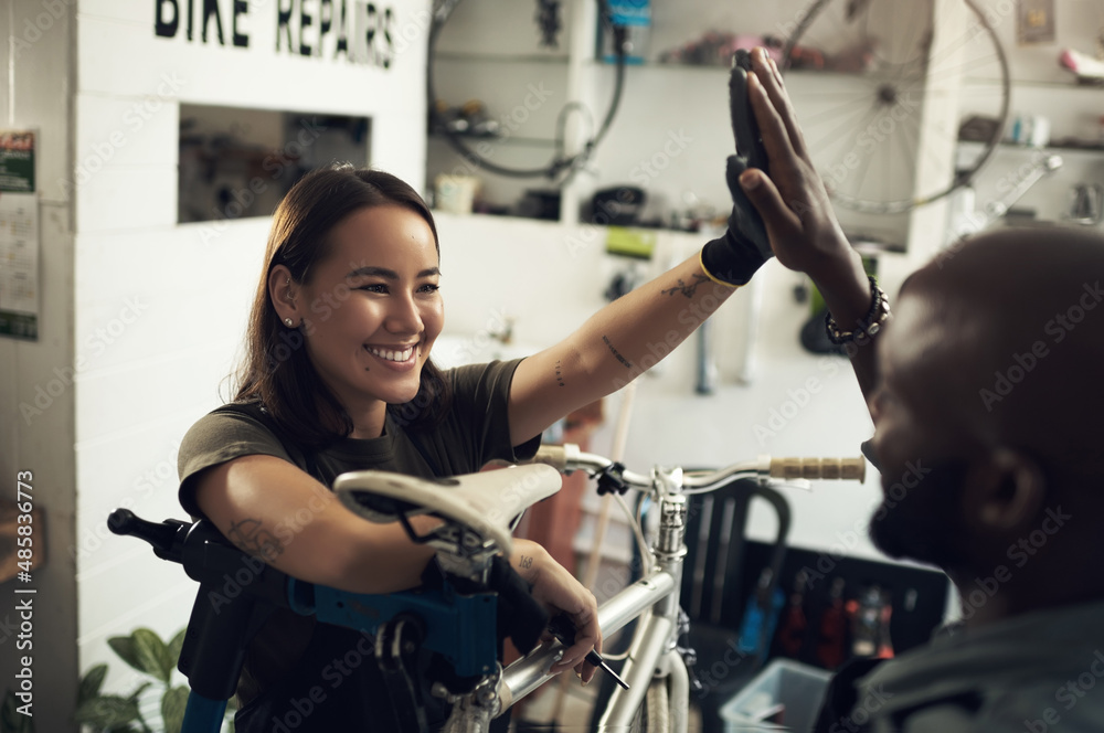 Good job on the fresh paint. Shot of two young business owners standing together in their bicycle sh