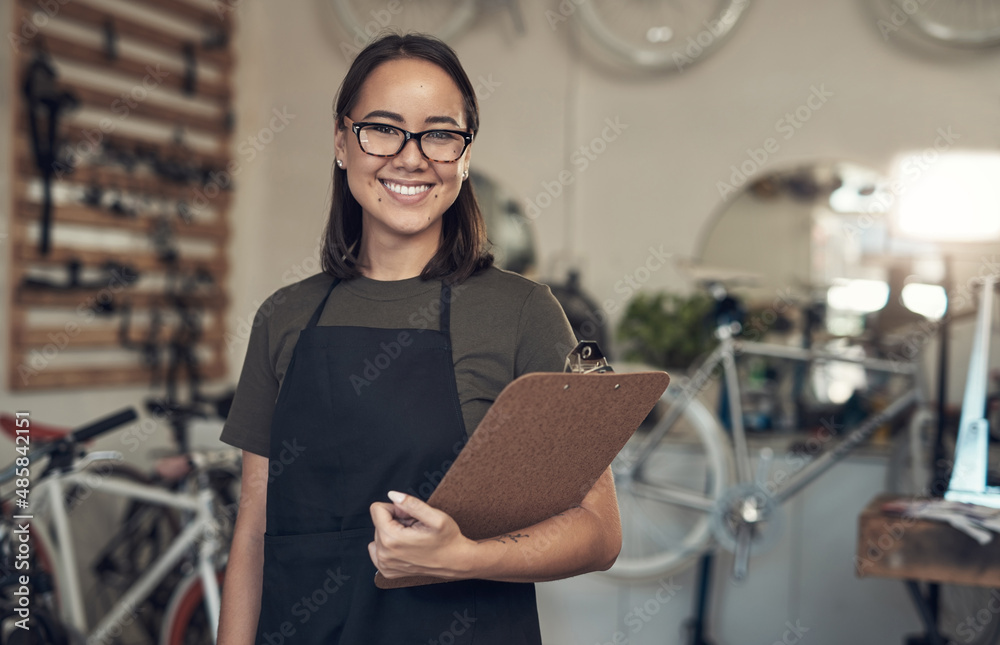 Just finished up with a stocktake. Shot of an attractive young woman standing alone in her bicycle s