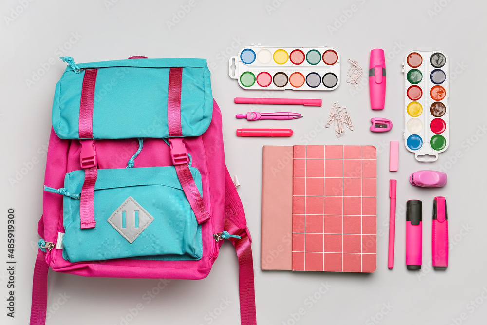 Set of stationery with school backpack on white background