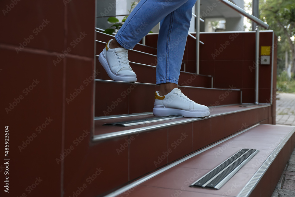 Woman walking downstairs outdoors