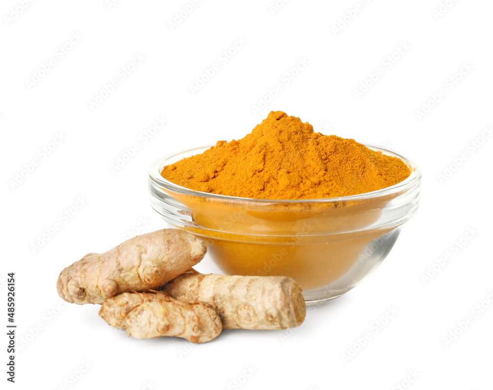 Bowl of turmeric powder and roots on white background