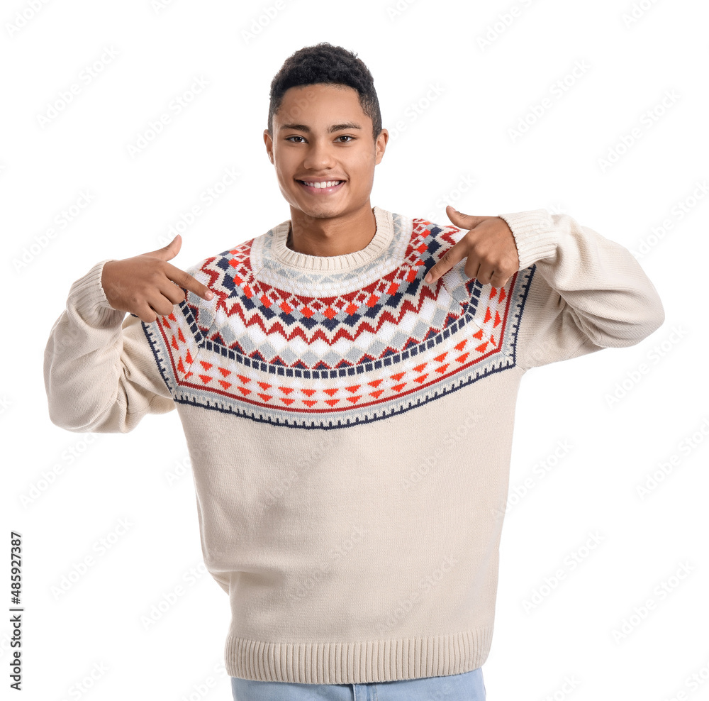 Handsome African-American guy in knitted sweater on white background