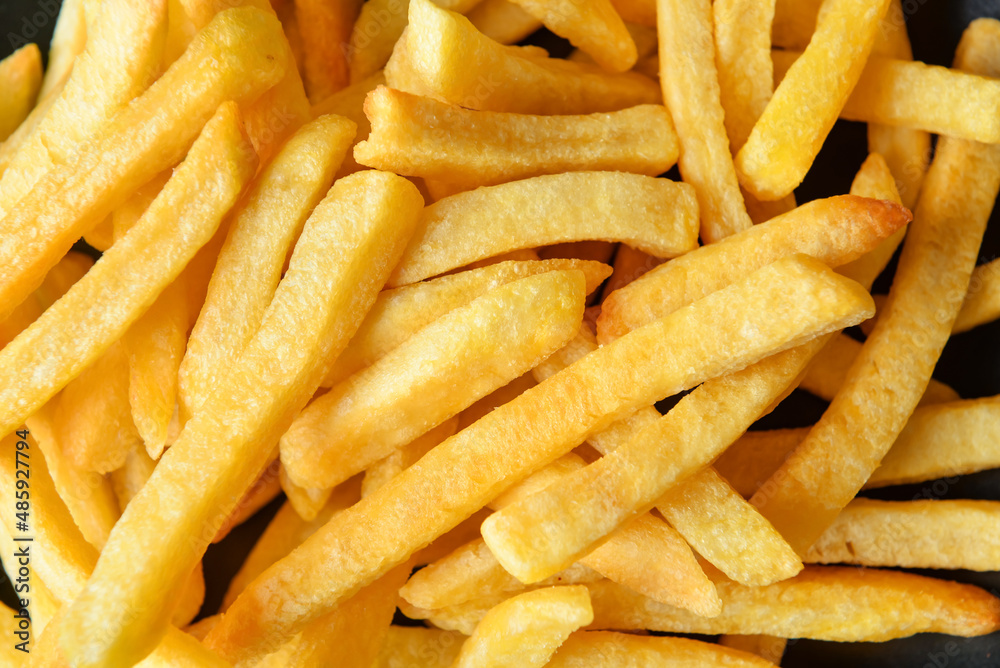 Tasty french fries as background, closeup