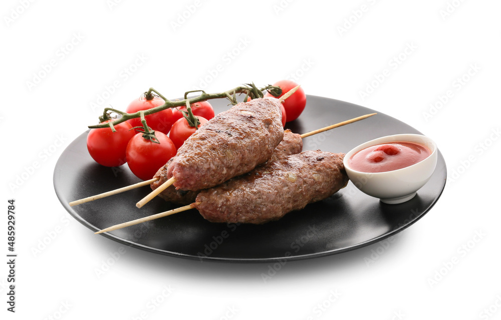 Plate of skewers with tasty lula kebab, tomatoes and sauce isolated on white background