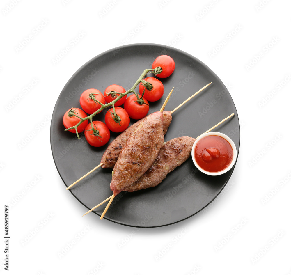 Plate of skewers with tasty lula kebab, tomatoes and sauce isolated on white background