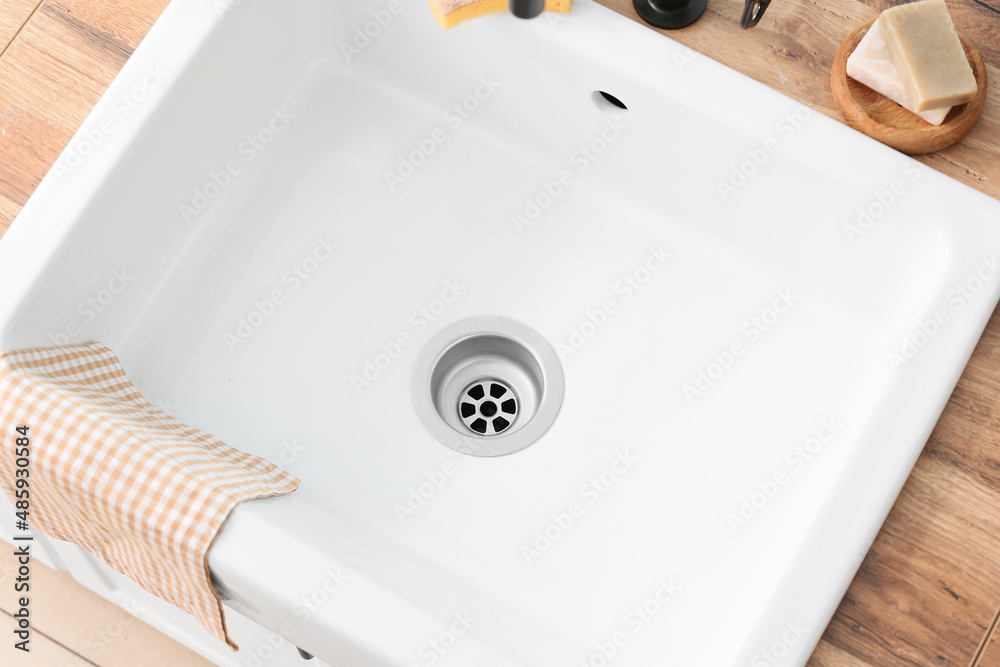 Ceramic sink with napkin in kitchen, closeup