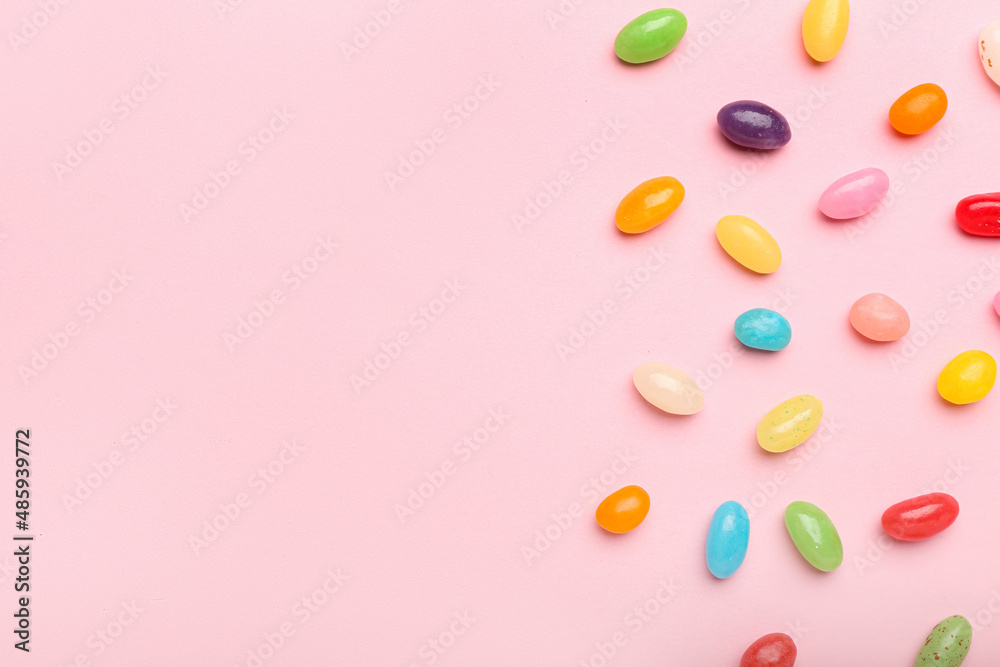 Multicolored jelly beans on color background