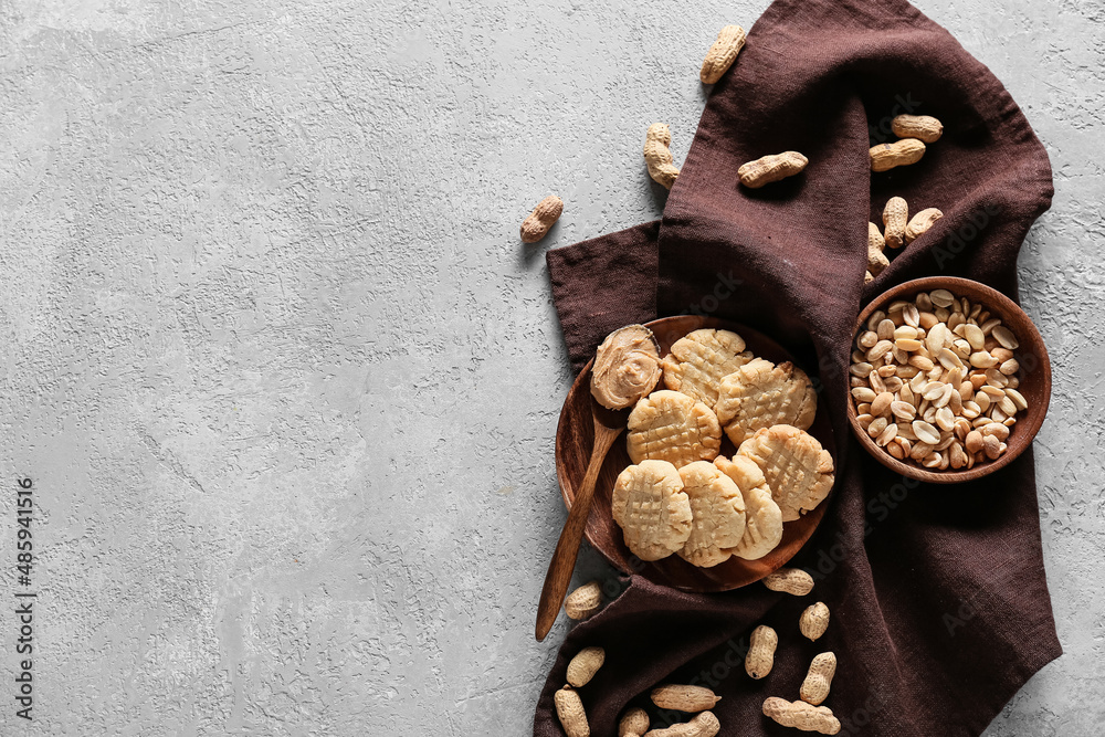 Plate with tasty peanut cookies on grey background