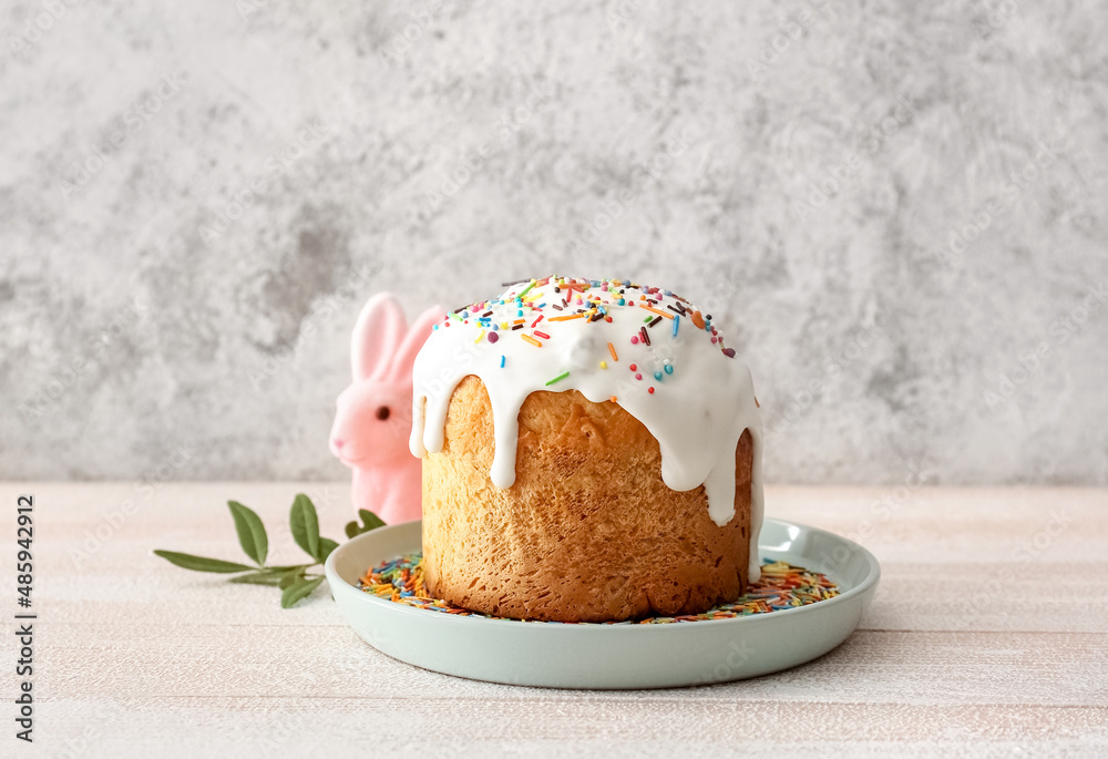 Plate with delicious Easter cake on table