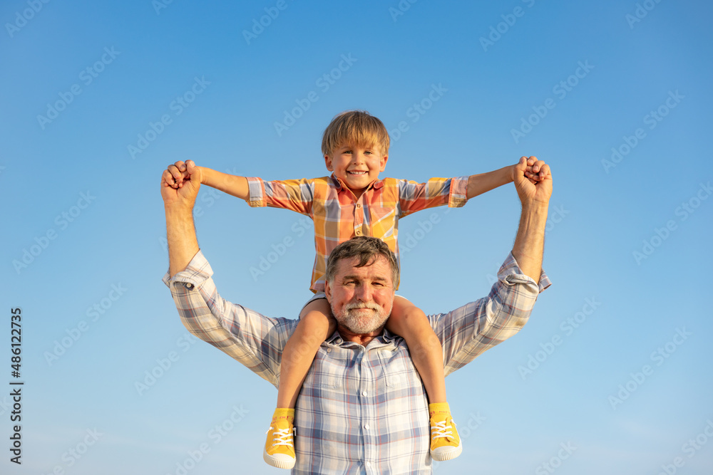 Grandfather and boy having fun outdoor