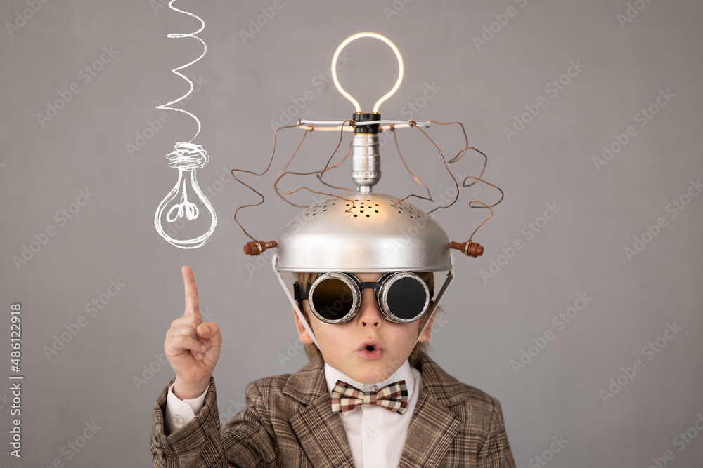 Smart child wearing funny helmet with illuminated lightbulb