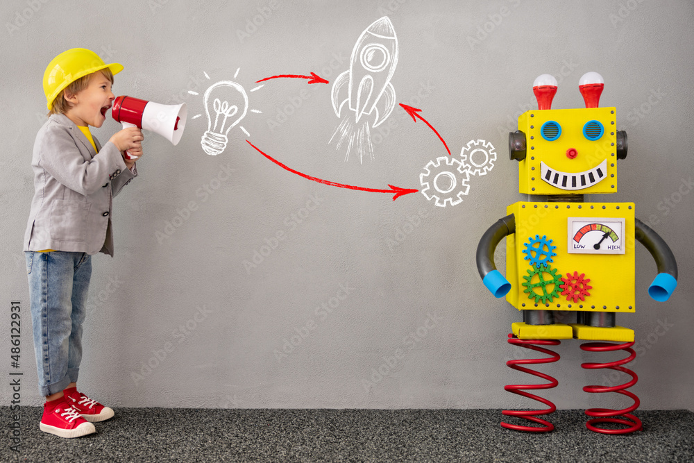 Happy child playing with robot