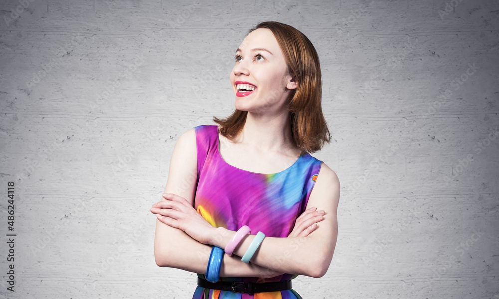 Smiling woman standing with folded arms