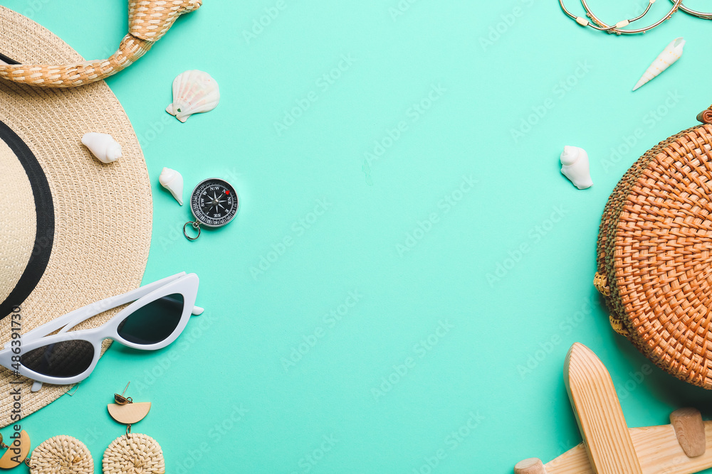 Set of beach accessories with vintage compass on color background