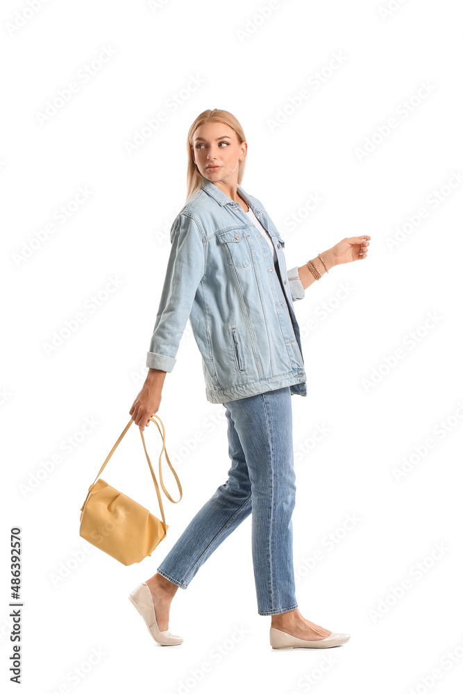 Fashionable young woman in stylish jeans clothes on white background