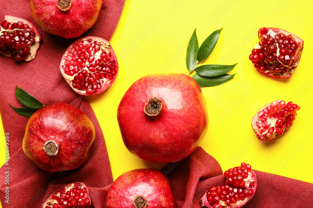 Ripe delicious pomegranate on yellow background