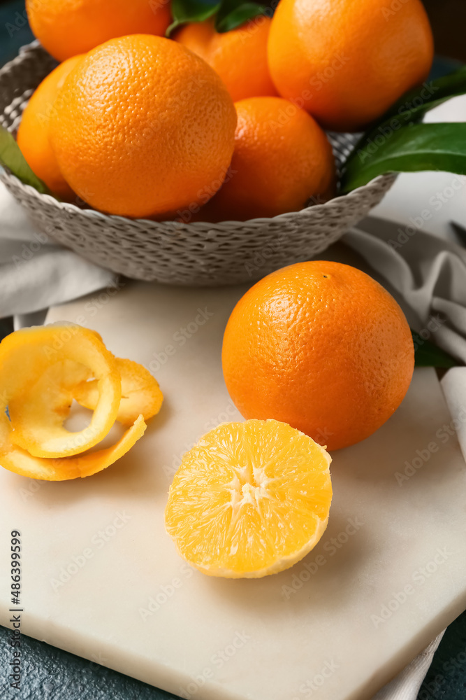 Board with fresh juicy oranges on table