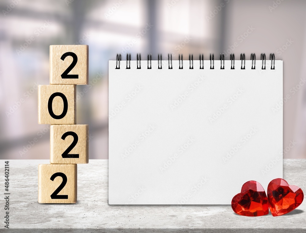 2022 cubes with red heart shape and empty notebook on table, Love and Happy Valentine day concept