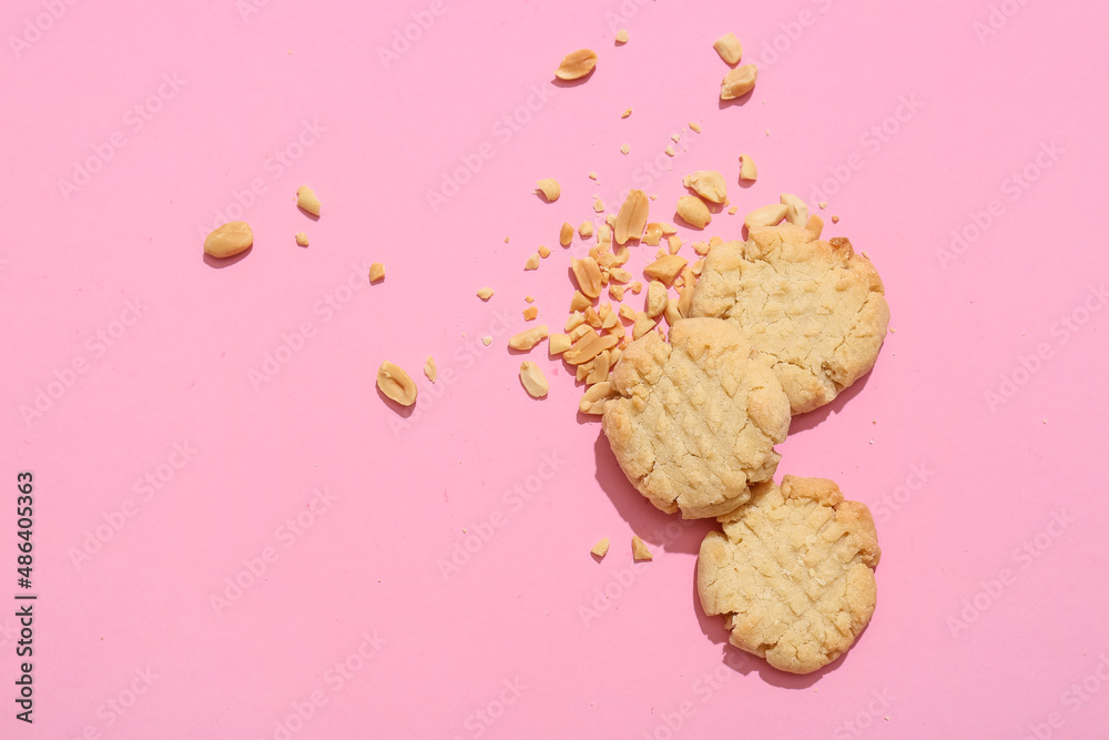 Tasty peanut cookies on pink background