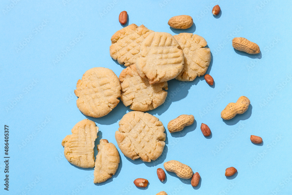 Tasty peanut cookies on blue background